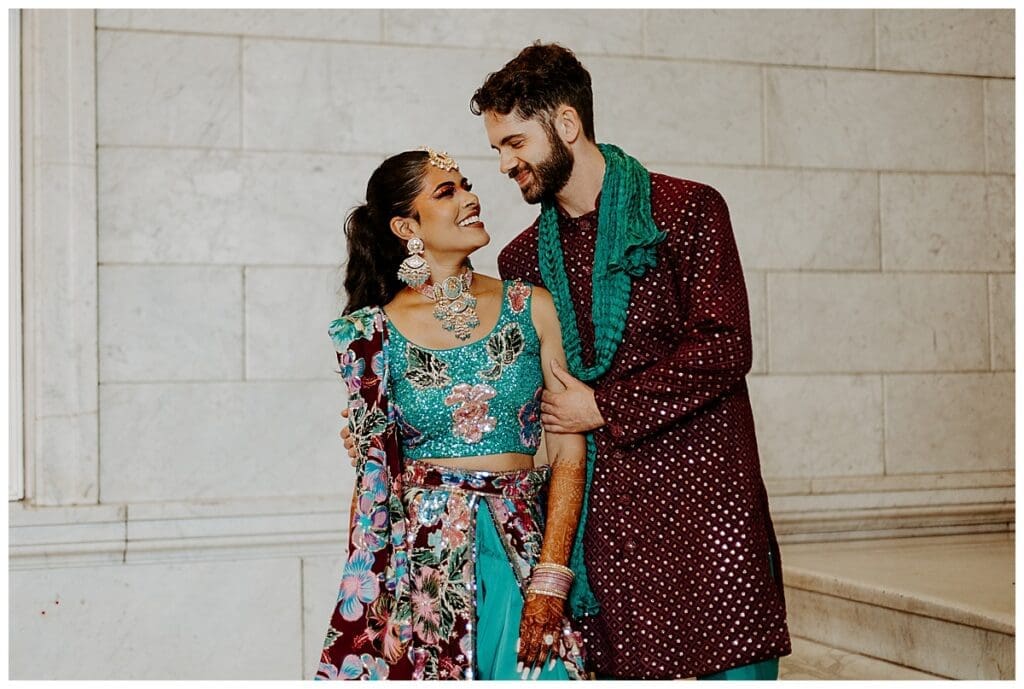 Aarushi and Shane posing together in traditional Indian fusion wedding outfits at the Lumber Exchange in Minneapolis