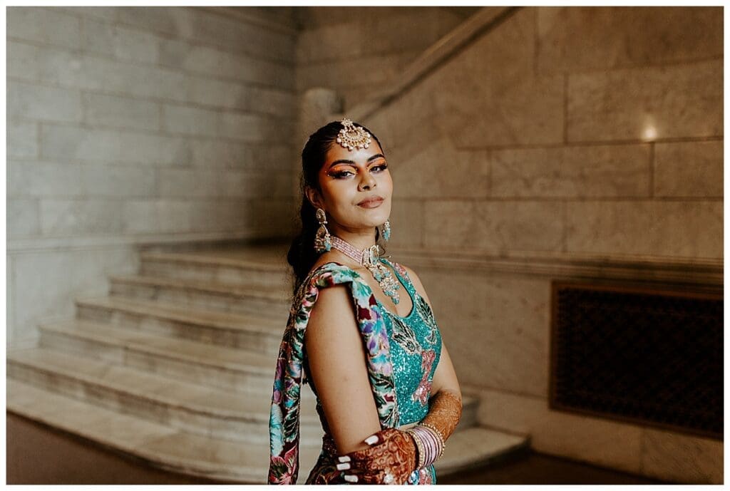 Aarushi in her Indian fusion bridal outfit on the marble staircase inside the Lumber Exchange in downtown Minneapolis