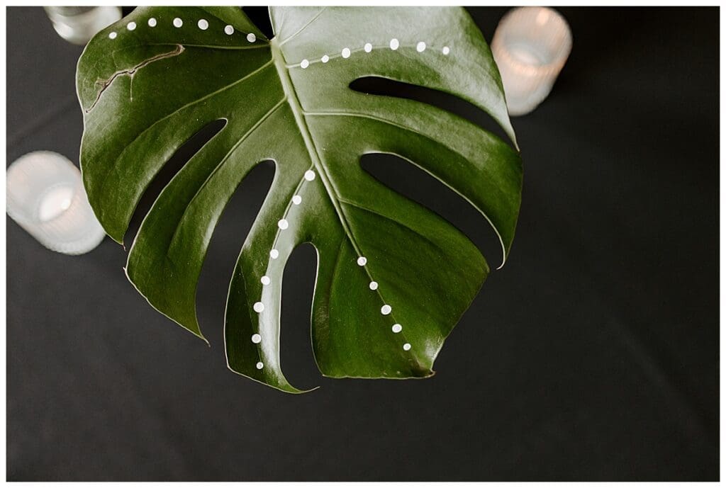 Tropical leaf decoration detail from Aarushi and Shane's jungle rave sangeet in Minneapolis