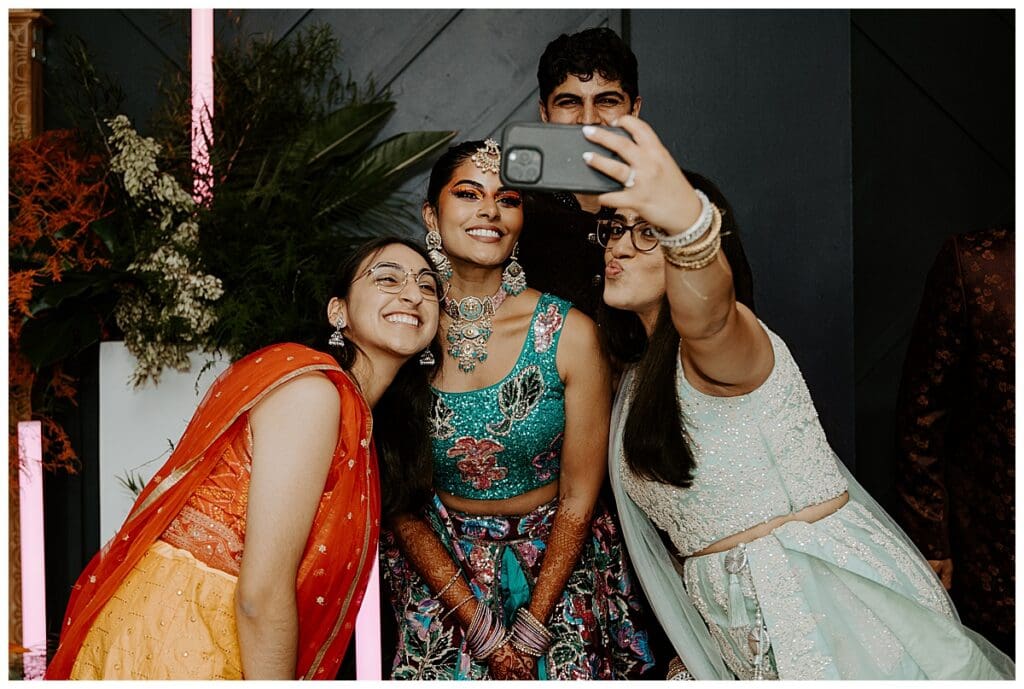 Aarushi taking a selfie with guests during the sangeet at the Lumber Exchange Minneapolis