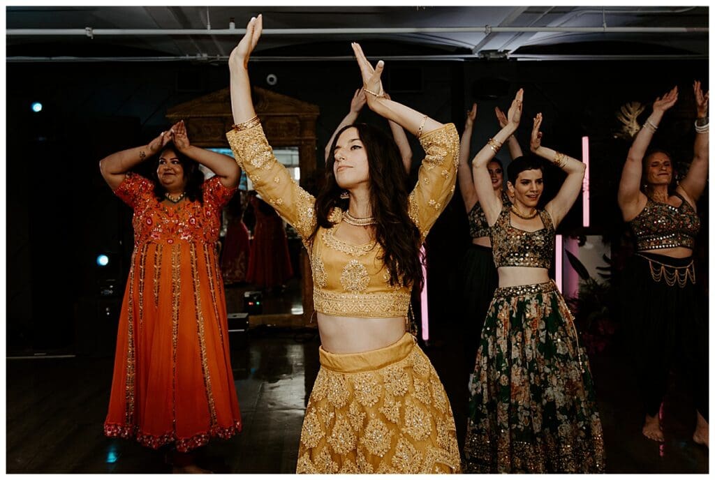 Dancers performing at the sangeet at the Lumber Exchange during Aarushi and Shane's Minneapolis Indian wedding