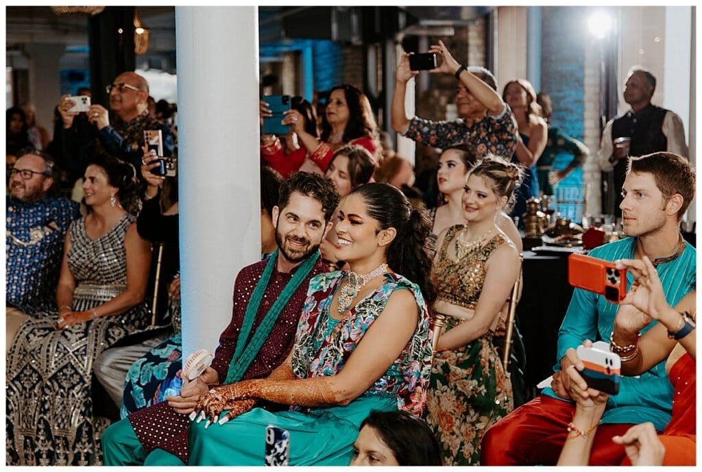 Guests watching sangeet performances at Aarushi and Shane's Indian wedding weekend at the Lumber Exchange Minneapolis"