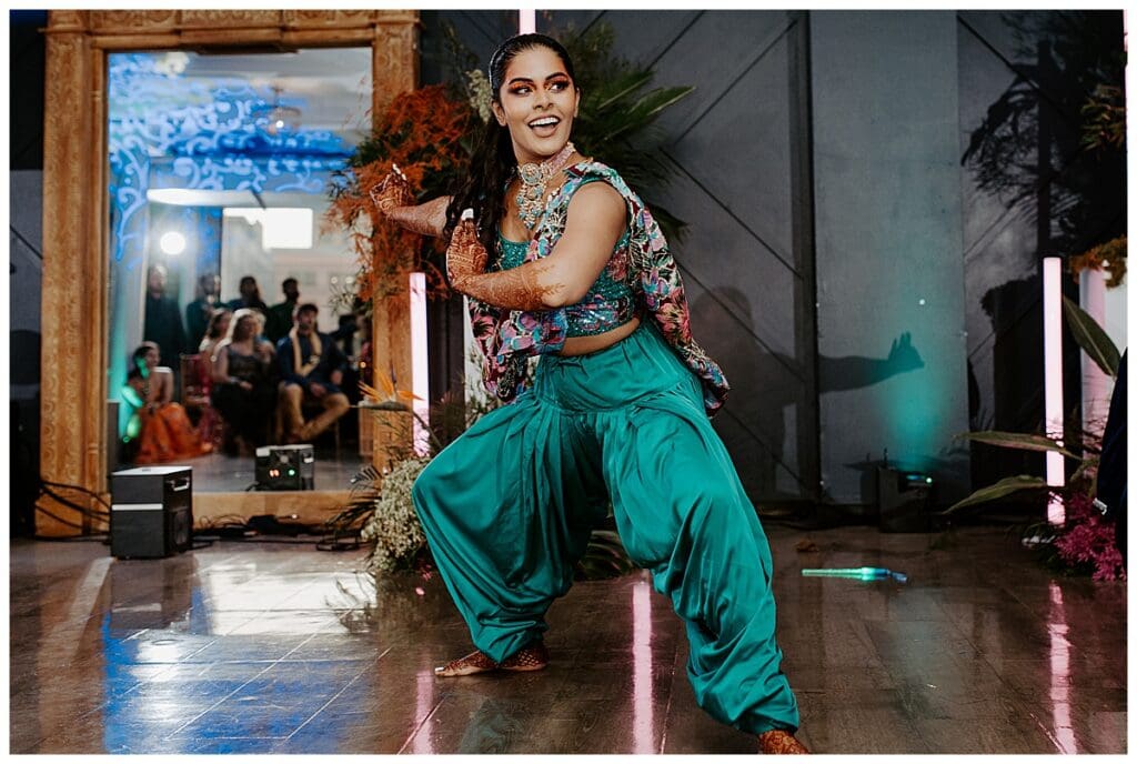 Aarushi in turquoise Indian outfit performing at her sangeet at the Lumber Exchange in Minneapolis