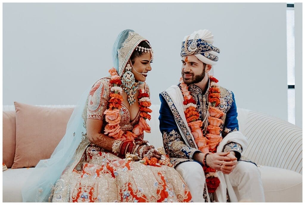 Aarushi and Shane seated together during their Hindu wedding ceremony at Mosaic Venue Minneapolis
