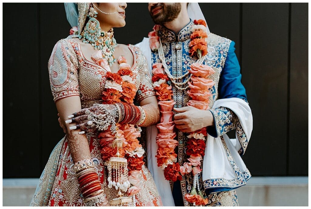 Aarushi and Shane in full traditional Hindu wedding attire with floral garlands at Mosaic Venue Minneapolis