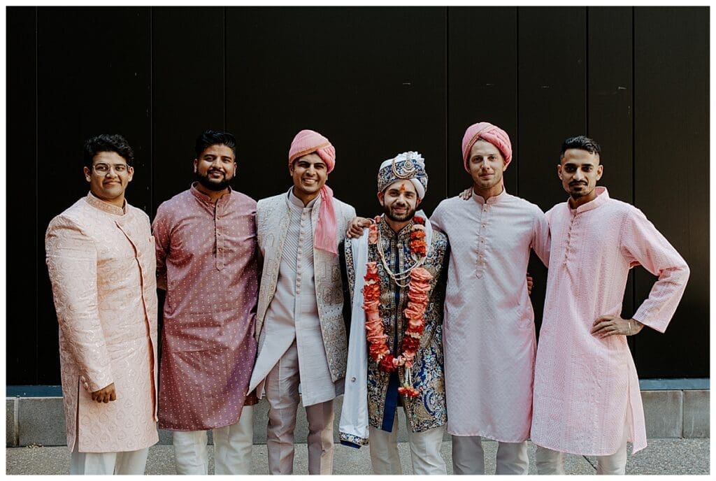Shane with his groomsmen in matching pink Indian wedding outfits at Mosaic Venue Minneapolis
