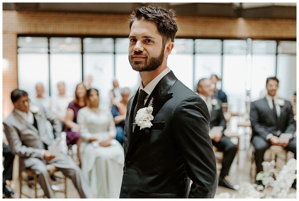Shane waiting at the altar during the Christian wedding ceremony at the Lumber Exchange Minneapolis