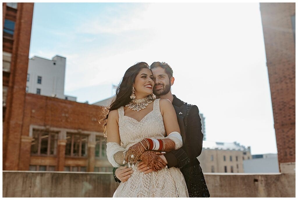 Aarushi and Shane close up portrait on the rooftop of the Lumber Exchange with the Minneapolis skyline