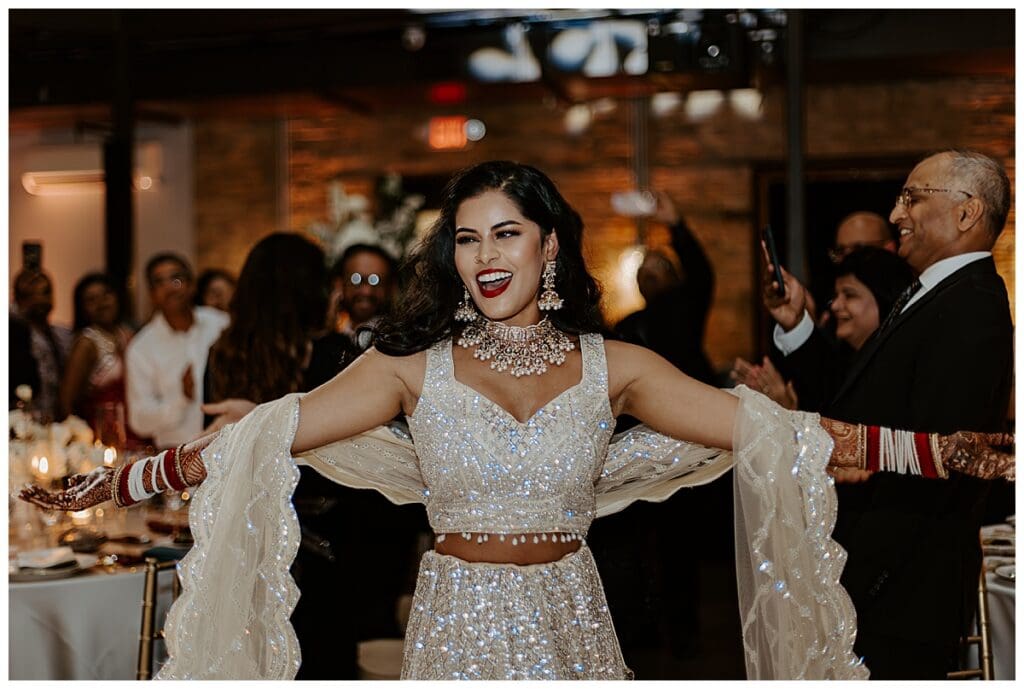 Guests celebrating during the reception at Aarushi and Shane's Indian fusion wedding at the Lumber Exchange Minneapolis