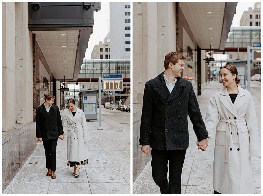 Meredith and Alec walking together through downtown Minneapolis during their winter engagement session