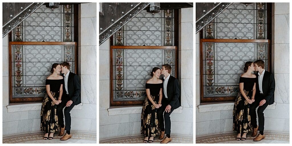 Meredith and Alec portraits by the decorative windows inside Minneapolis City Hall