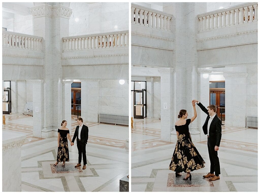 Meredith and Alec walking and dancing together in the marble rotunda at Minneapolis City Hall during their engagement session